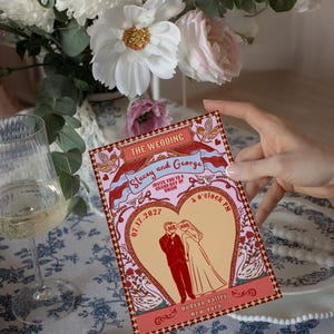 Tunnel of Love inspired vintage circus wedding invitation suite mockup: 5x7 main invitation with bride, groom, swans, and heart-shaped archway design; 4x6 details card; 5x3.5 RSVP card in two variations with QR code option; red diamond harlequin pattern backs with S+G heart monogram; bonus 10.5x2 belly band. Whimsical retro carnival-style editable printable wedding stationery template set by Krist Lunaire Co.