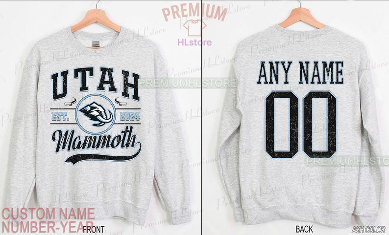 K&ouml;nnte beinhalten: Hellgraues Sweatshirt mit dem Text "UTAH Mammoth" und einem Mammut-Logo auf der Vorderseite. Auf der R&uuml;ckseite stehen "ANY NAME" und die Nummer "00". Das Sweatshirt ist aschfarben.