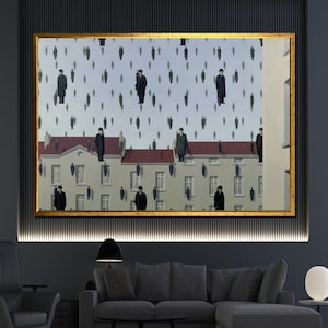 May include: A framed art print featuring a surrealist painting. The artwork depicts numerous figures in black coats and hats floating in the sky above a building with a red roof. The frame is gold, and the overall color palette is muted.