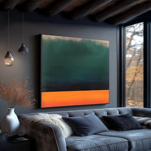 May include: An abstract painting with a dark green and black upper section, a vibrant orange lower section, and a gold border. The artwork hangs above a gray sofa with decorative pillows in a modern living room setting.