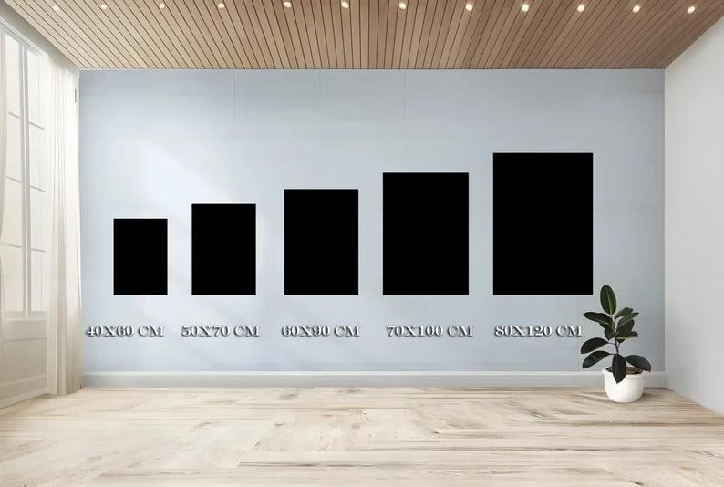 May include: Five black rectangular art prints of varying sizes are displayed on a light gray wall. The sizes are labeled in centimeters: 40x60 cm, 50x70 cm, 60x90 cm, 70x100 cm, and 80x120 cm. A small potted plant sits on the floor.