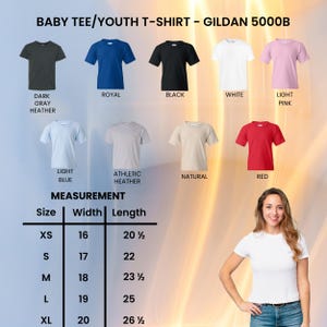 May include: A display of various colored baby and youth t-shirts, including dark gray, royal blue, black, white, and light pink. The shirts are arranged with a measurement chart showing sizes XS to XL, with width and length in inches. A woman is standing next to the shirts.
