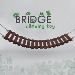 May include: A brown wooden bridge toy with rope ends. The bridge is curved and has a textured wood grain. The toy is labeled "BRIDGE climbing toy" with green cartoon animals.