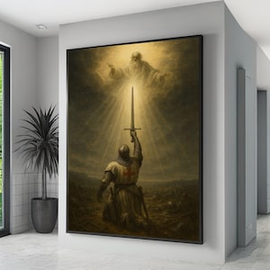 May include: A framed print depicting a medieval knight kneeling and holding a sword towards a divine figure in the sky. The artwork features a warm color palette with a focus on light and shadow, creating a dramatic and historical scene.