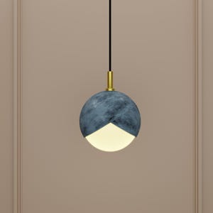 May include: A modern pendant light with a blue and white globe-shaped shade. The shade is made of a textured material and has a gold metal accent at the top.