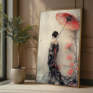 Può includere: Un'opera d'arte incorniciata raffigura una donna in un tradizionale kimono giapponese che tiene un parasole rosso. L'opera presenta una cornice dorata, accenti floreali e una morbida tavolozza di colori. Il kimono della donna è nero con motivi floreali dorati.