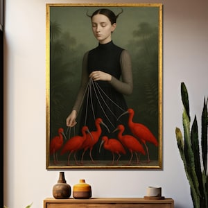 May include: A framed artwork depicts a woman in a black dress holding strings attached to six bright red birds. The background features a dark green, jungle-like setting. The artwork is displayed in a gold frame.