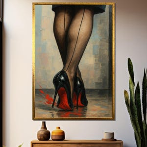 May include: A framed artwork showing a pair of legs in black seamed stockings and black high-heeled shoes with red soles. The painting has a gold frame and is displayed on a wall above a wooden cabinet.