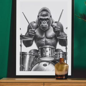 May include: A black and white illustration of a gorilla playing the drums. The gorilla is sitting on a drum stool and has a serious expression on its face. The drums are a standard drum set with a bass drum, snare drum, and two toms.