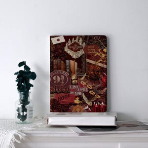 May include: A burgundy-colored journal with a collage of Harry Potter-themed images and text. The cover features illustrations of the Marauder's Map, Platform 9 3/4, books, and other iconic symbols from the series. The words "brave, daring, confident" are also visible.