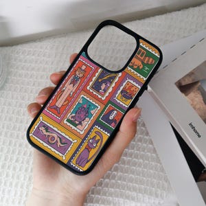 May include: Black phone case featuring a colorful collage of cartoon characters in postage stamp designs. The case has a black border and a glossy finish. The design includes a cat in a suit, a dragon, and other whimsical illustrations.