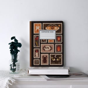 May include: A composition book featuring a brown cover adorned with a collage of vintage postage stamp designs in brown, orange, and cream hues. The book has a white label that reads "COMPOSITION BOOK".