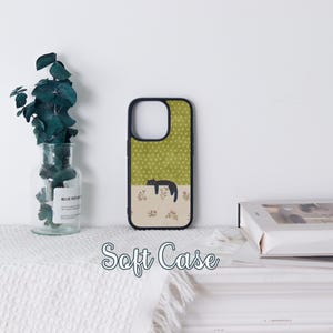 May include: A black and green soft phone case featuring a sleeping cat illustration. The top half has a green background with white polka dots, and the bottom half has a floral pattern. The text "Soft Case" is displayed at the bottom.
