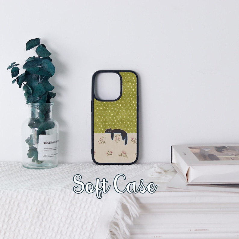 May include: A black and green soft phone case featuring a sleeping cat illustration. The top half has a green background with white polka dots, and the bottom half has a floral pattern. The text "Soft Case" is displayed at the bottom.