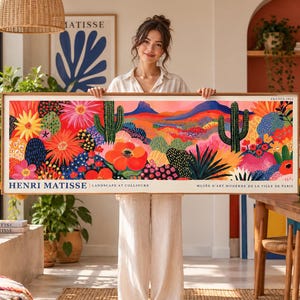 Könnte beinhalten: Ein rechteckiger gerahmter Kunstdruck mit einer lebendigen, farbenfrohen Landschaftsillustration mit Kakteen, Wüstenflora und Bergen. Der Text lautet HENRI MATISSE | LANDSCAPE AT COLLIOURE und MUSÉE D'ART MODERNE DE LA VILLE DE PARIS, FRANCE 1953.
