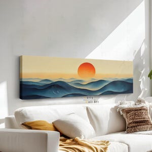 May include: A panoramic rectangular canvas wall art print featuring a stylised landscape with rolling dark blue hills and a large, vibrant orange sun set against a pale yellow sky. The artwork displays a smooth, gradient transition of colours.