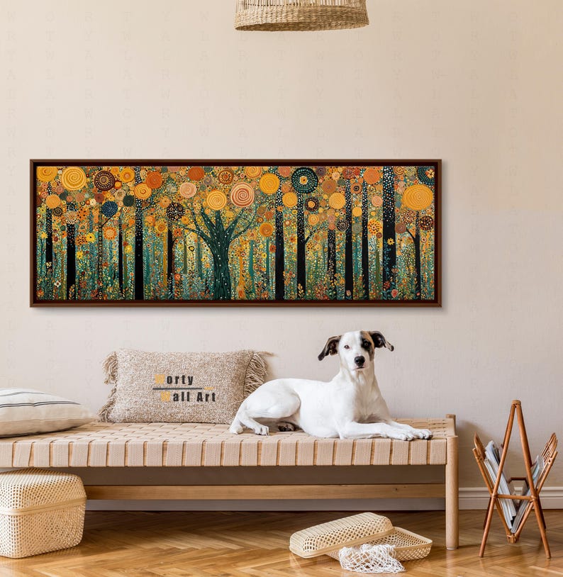 May include: A rectangular panoramic wall art piece featuring a stylized forest scene with dark vertical tree trunks and a dense canopy of golden, orange, and teal circular patterns. The artwork is enclosed in a thin, dark brown wooden frame.