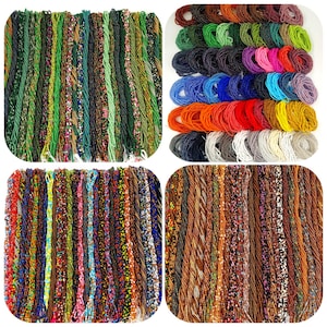 May include: A collection of beaded strands in various colors, including green, brown, orange, blue, and white. The beads are tightly strung together, creating a textured appearance. The strands are arranged in a grid-like pattern.