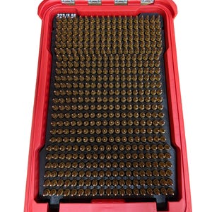 May include: Red ammunition storage case with a clear lid. The case is open, revealing rows of brass-colored bullets on a black insert. The text "223/5.56" is visible on the case.