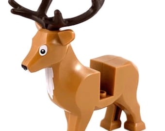 May include: A brown plastic toy deer figurine with dark brown antlers. The deer has a white patch on its chest, a black nose, and printed white eyes with black pupils. The body features a rectangular cutout on the back for building block compatibility.