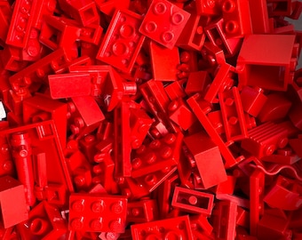 May include: A large pile of red LEGO bricks of various shapes and sizes.
