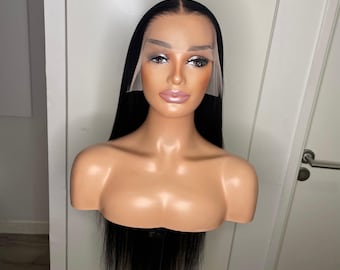 May include: A straight, long, black wig displayed on a mannequin head. The wig features a center part and a sheer lace front panel that extends across the forehead and temples, showing a natural hairline transition against the mannequin's skin.