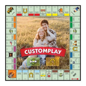 May include: A square board game featuring a central photograph of two people sitting in a field. The board has a red banner with the text CUSTOMPLAY CUSTOM EDITION. The perimeter includes various icons, text boxes, and colored property spaces.