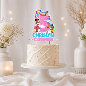 May include: A custom cake topper featuring a large pink number 5, colorful balloons, stars, a rainbow, and two cartoon characters. The text CHRISLYN CORNER is printed in blue and pink below the number. The topper is mounted on two thin sticks.