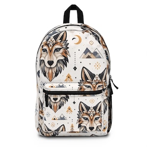 May include: White backpack with a repeating pattern of stylized wolf faces, mountains, and geometric shapes in shades of brown, tan, and gray. Features a black top handle, zipper, and mesh side pocket. The design has a bohemian or Native American aesthetic.