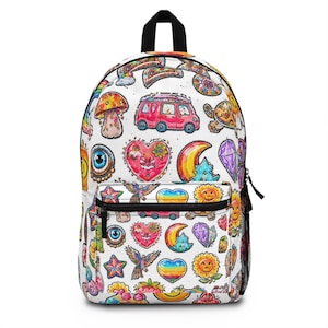 May include: White backpack with a black handle and zipper. The backpack is covered in colorful, whimsical illustrations of rainbows, hearts, mushrooms, and a red van. A black mesh pocket is on the side.