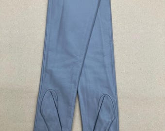 May include: A pair of long, light blue leather gloves. The gloves are laid flat, showing the full length from the fingertips to the upper arm. The gloves have a classic design with a smooth texture.