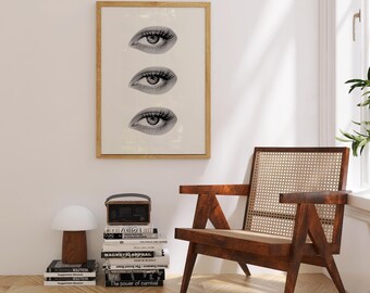 Puede incluir: Un cuadro enmarcado con tres ilustraciones de ojos estilizados en blanco y negro. La obra de arte cuelga sobre una silla de madera con respaldo de mimbre. Una pila de libros y una lámpara con forma de hongo están en el suelo.