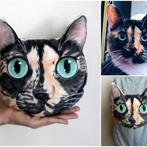 May include: A custom-made cat pillow with a realistic illustration of a calico cat with green eyes. The pillow is soft and cuddly, perfect for snuggling.