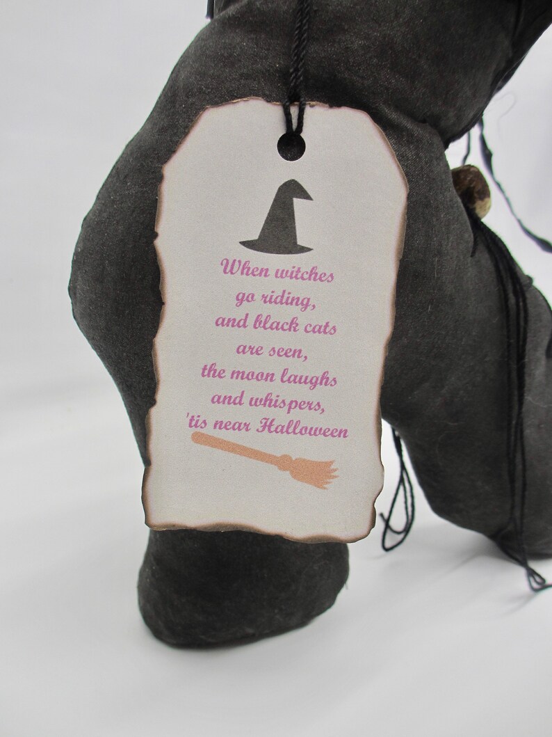 May include: A black fabric witch's boot with a white tag that reads "When witches go riding, and black cats are seen, the moon laughs and whispers, 'tis near Halloween".