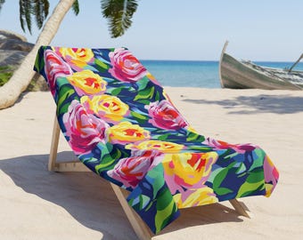 Könnte beinhalten: Ein Strandstuhl mit einem floralen Handtuch. Das Handtuch hat einen leuchtend blauen Hintergrund mit großen rosa, gelben und grünen Blumen.