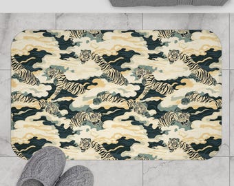 May include: Rectangular bath mat featuring a repeating pattern of tigers amidst stylized clouds. The design incorporates shades of cream, navy, and gold. The mat is placed on a tiled floor, with a pair of gray slippers visible.