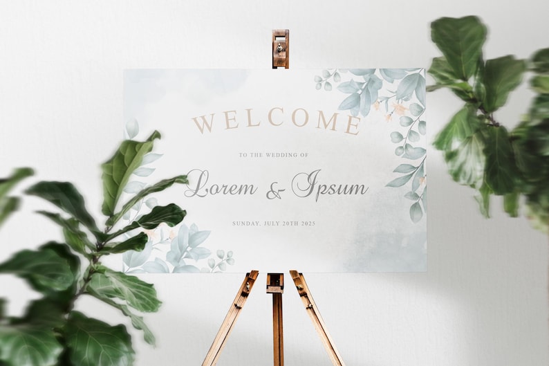 K&ouml;nnte beinhalten: Ein Aquarell-Willkommensschild f&uuml;r eine Hochzeit mit einem floralen Design in Blaut&ouml;nen und Gr&uuml;n. Das Schild lautet "Willkommen zur Hochzeit von Lorem & Ipsum, Sonntag, 30. Juli 2023".