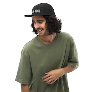 May include: A black 5-panel cap with a white embroidered logo that says "DR. ROCK"