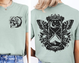 May include: A light green t-shirt with a black skull with flowers on the left chest and a black hourglass with a butterfly and skulls on the back.