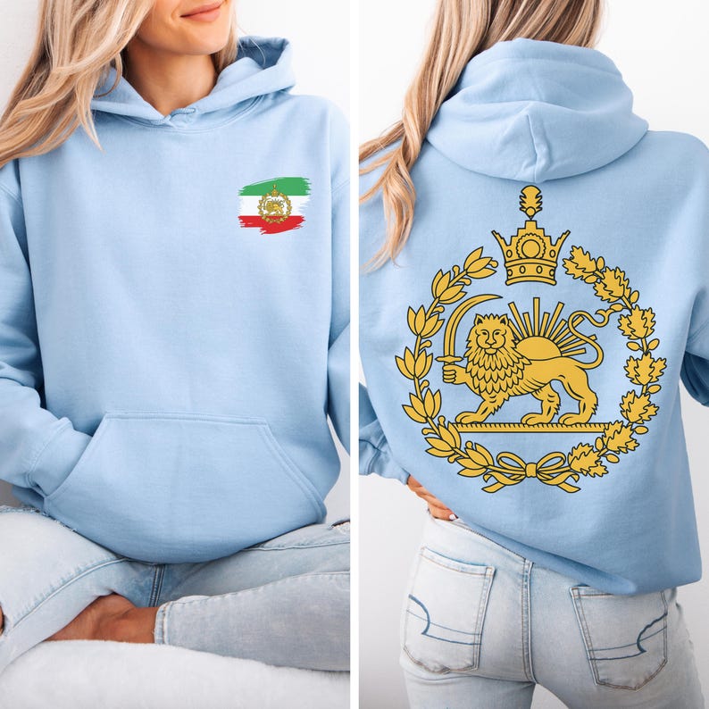 May include: Light blue hoodie with a front pocket and a hood. The front features a small emblem of a flag with red, white, and green colors. The back displays a golden emblem of a lion holding a sword, surrounded by a wreath.