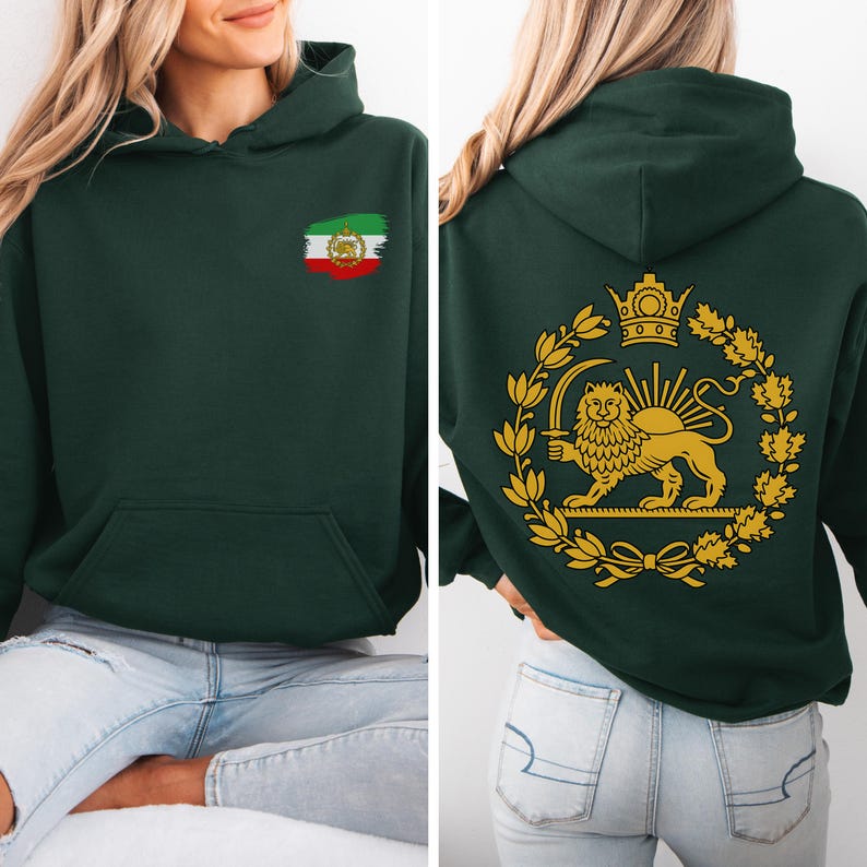 May include: Dark green hoodie with a front pocket and hood. The front features a small Iranian flag design. The back displays a gold emblem of a lion holding a sword, surrounded by a wreath and crown. The hoodie is made of a soft material.