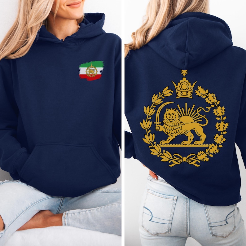 May include: Navy blue hoodie with a front pocket and a hood. The front features a small Iranian flag design. The back displays a gold emblem of a lion holding a sword, surrounded by a wreath and crown. The hoodie is made of a soft material.