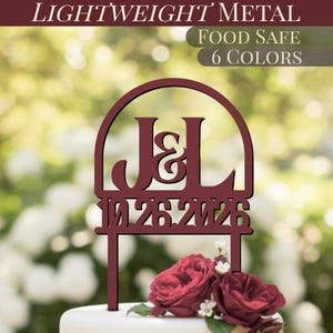 May include: Burgundy metal cake topper with the initials "J&L" and the date "10.26.2026". The topper is in front of a blurred background of greenery and white flowers. The words "LIGHTWEIGHT METAL", "FOOD SAFE", and "6 COLORS" are at the top.