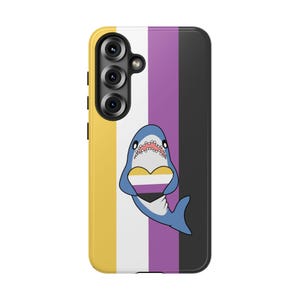 May include: A phone case with a non-binary pride flag design. The case features a yellow, white, purple, and black striped background. A cartoon shark holding a heart with the non-binary flag colors is centered on the case.