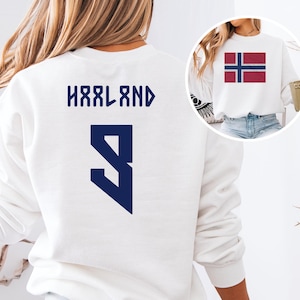 A white sweatshirt with the text "HÄRLAND" and the number "9" printed on it, along with a graphic of the Norwegian flag.