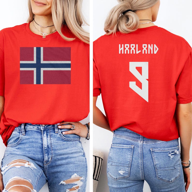 A woman wearing a red t-shirt with the flag of Norway and the number 9 on the back, paired with distressed jeans.