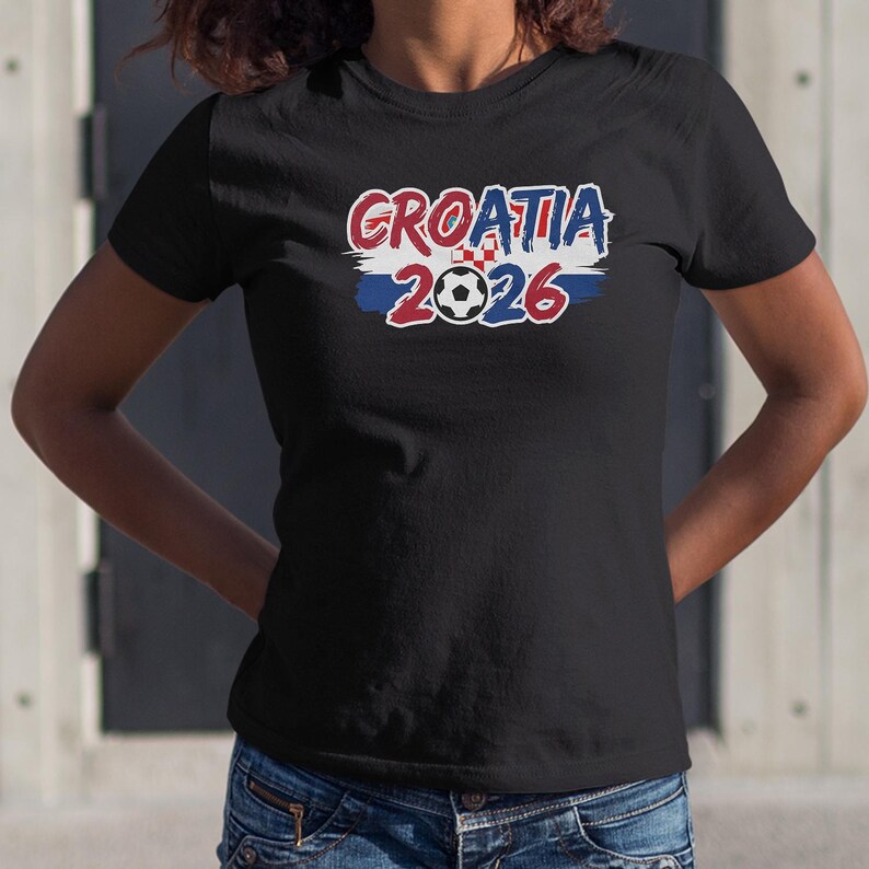 A person wearing a black t-shirt with the text "GROATIA 2026" printed on it.