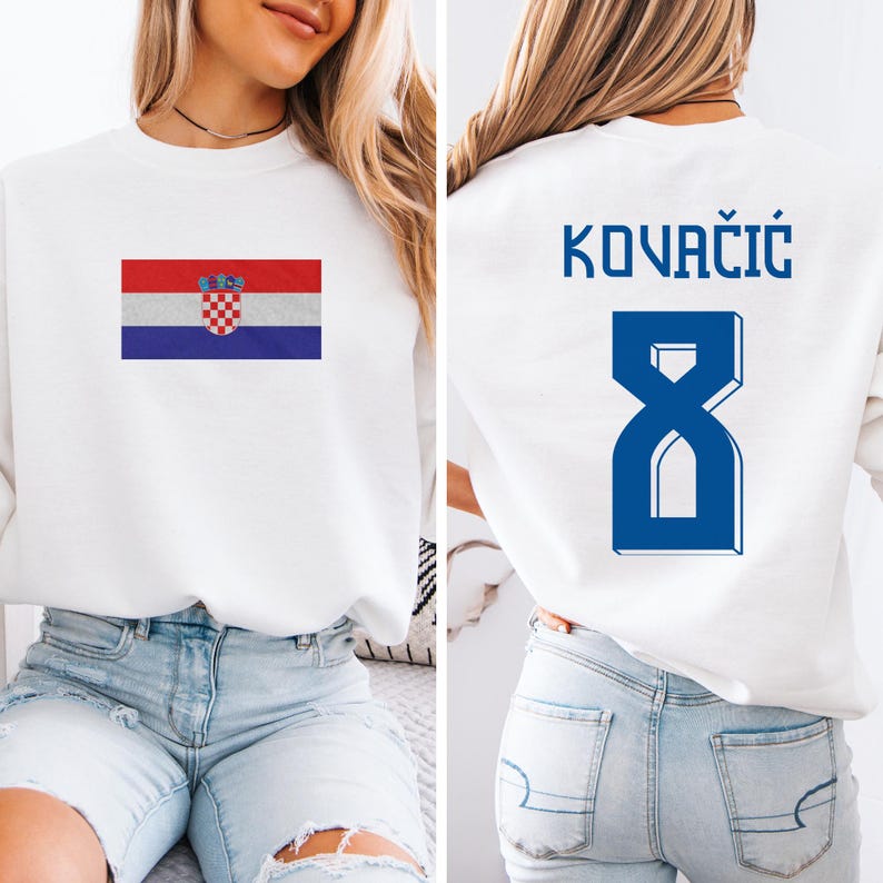 A woman wearing a white sweatshirt with the Croatia national flag and the number 8 on the back.