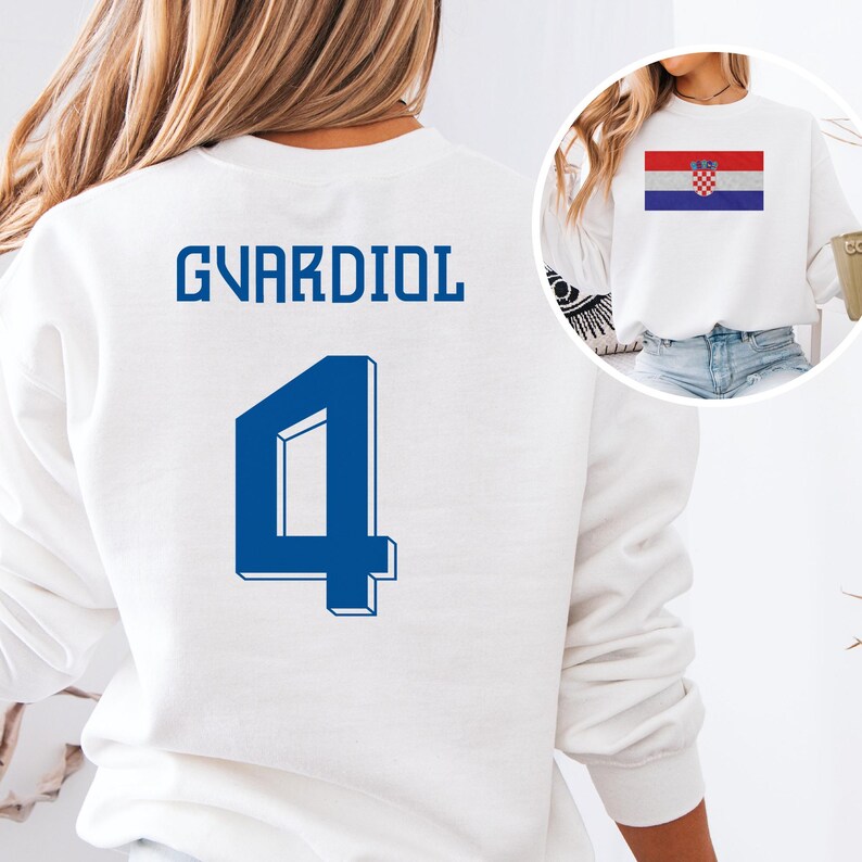 A white sweatshirt with the name 'GVARDIOL' and the number '4' printed on it, along with a small image of the Croatia national flag.