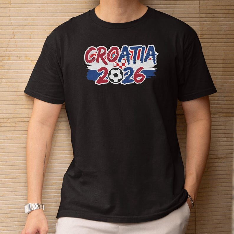 A black t-shirt with the text "GRATIA 2016" printed on it, along with a soccer ball graphic.